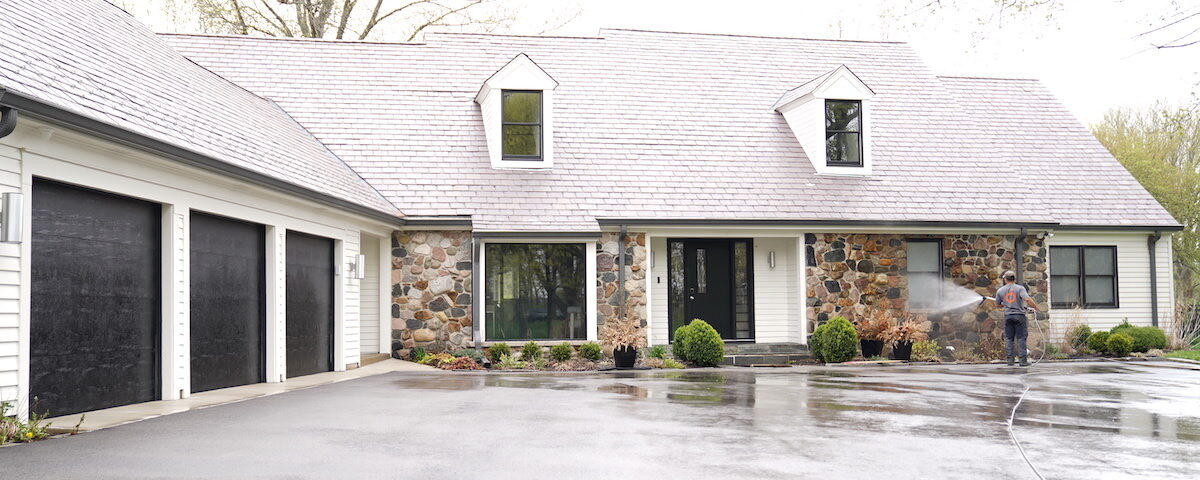 forte surfaces cleaning the side of a house