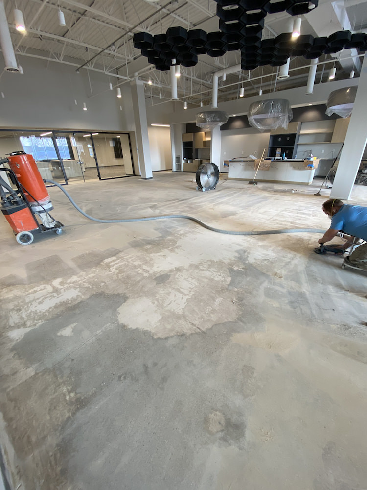 industrial floor before epoxy was installed - forte team prepping the surface for installation