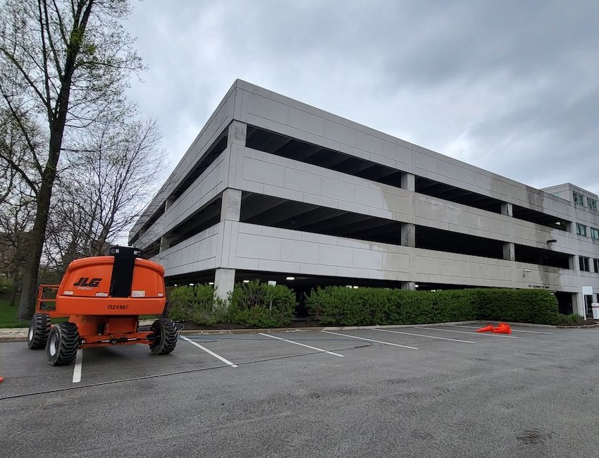 an orange lift is parked in front of a building that just had an exterior building cleaning