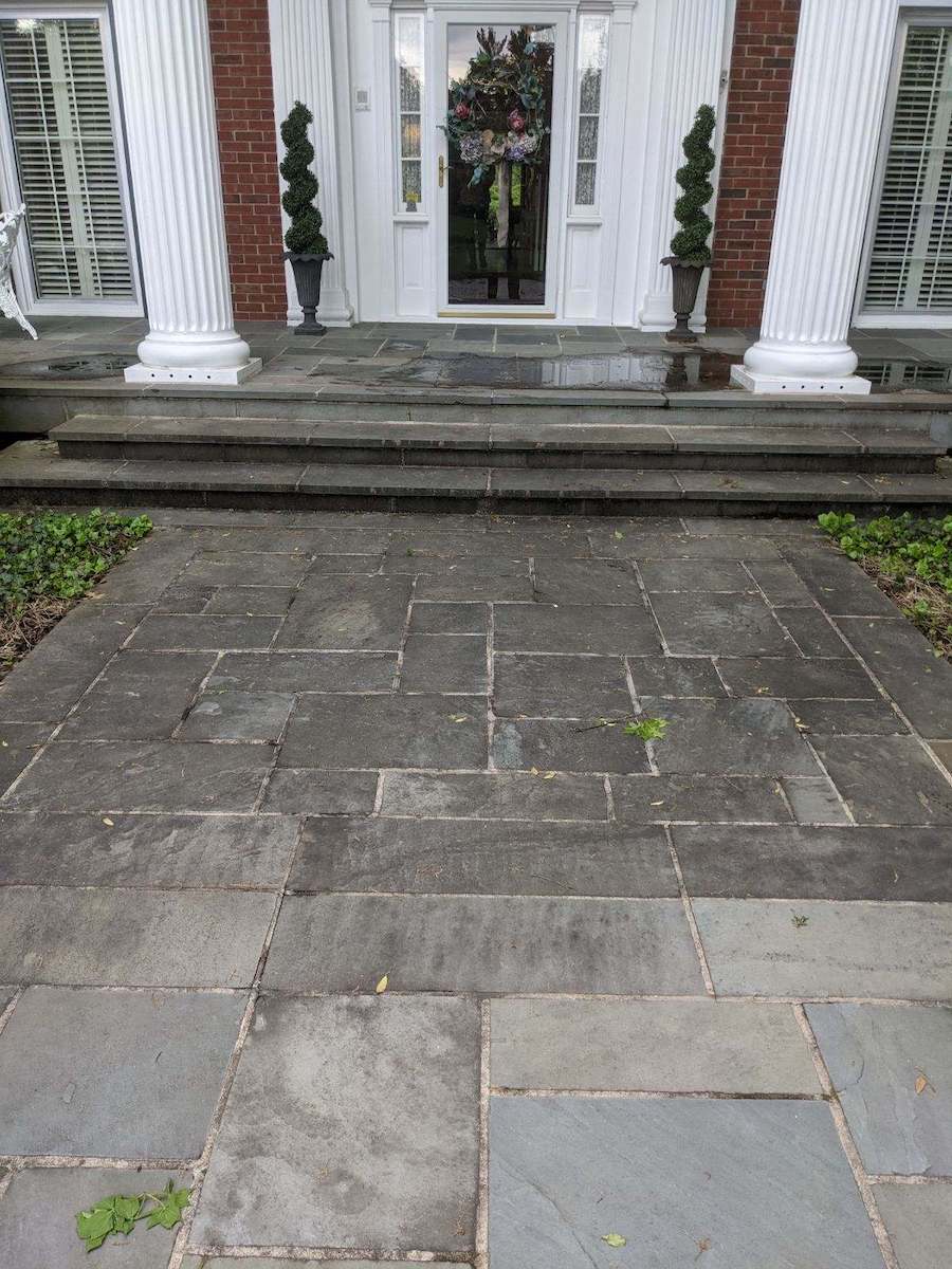 a stone walkway leading to the front door of a house