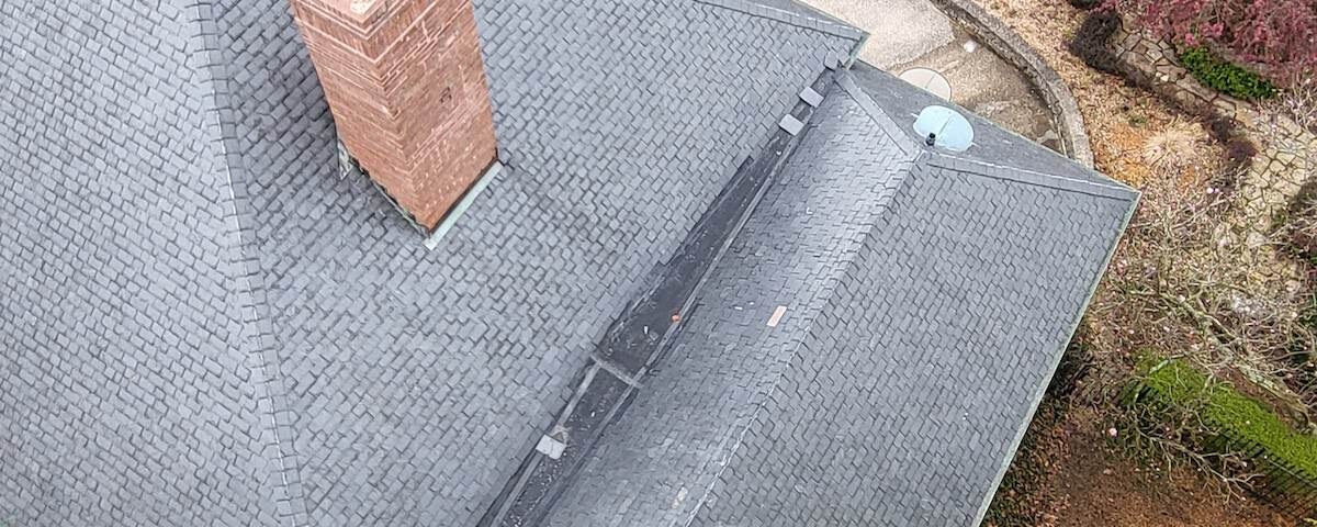 an aerial view of a house with a chimney on the roof that was washed