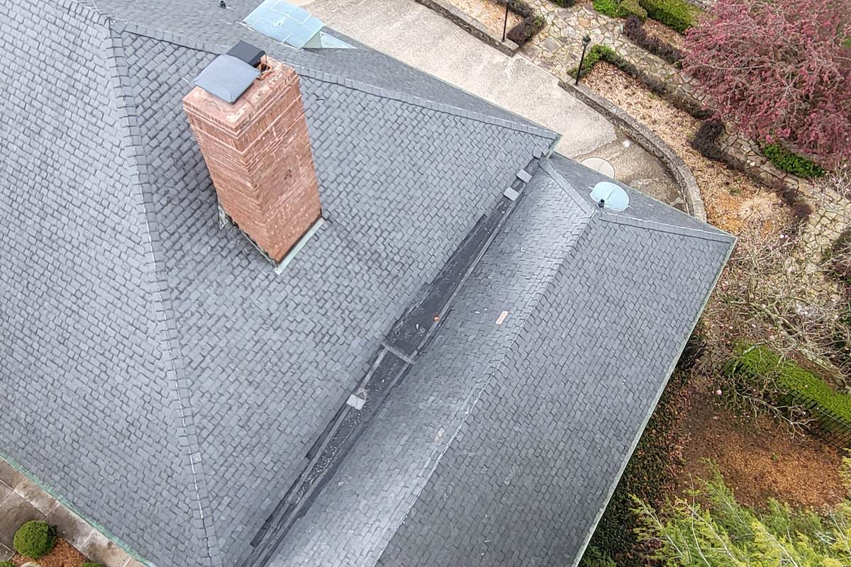 an aerial view of a house with a chimney on the roof that was washed
