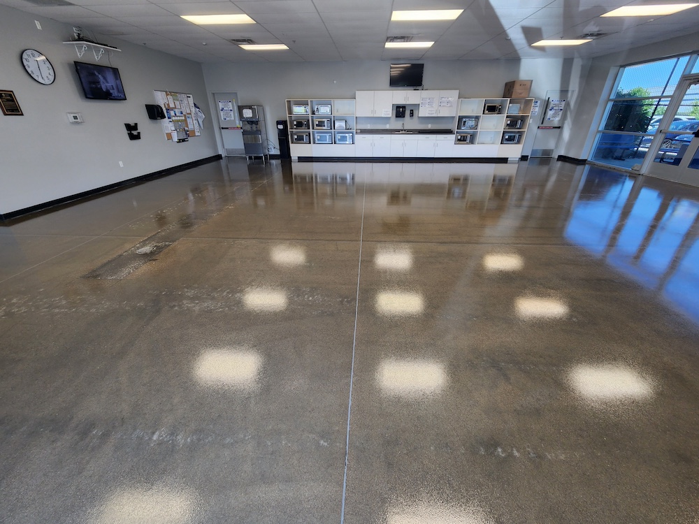 a large empty room with a ceiling that looks like a honeycomb that had concrete sealing completed