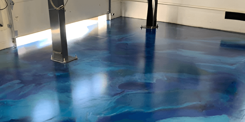 a blue epoxy floor in a garage