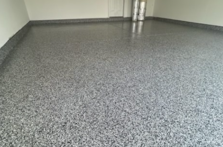 a garage with a gray epoxy floor and white walls