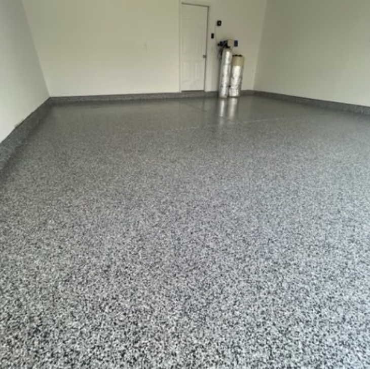 a garage with a gray epoxy floor and white walls
