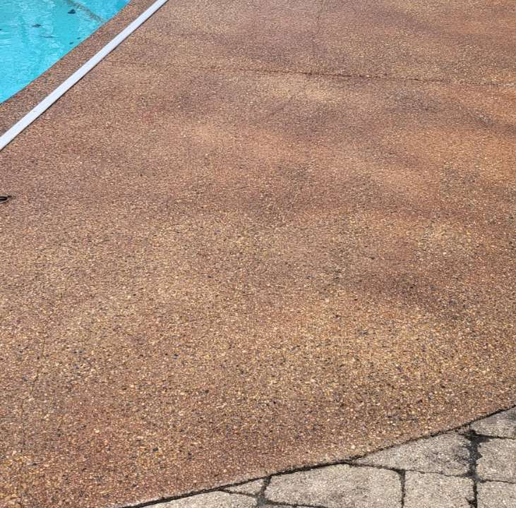 a swimming pool with a brown concrete floor