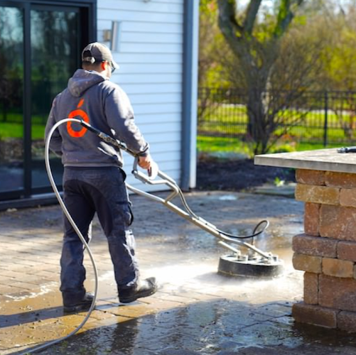 a man is using a machine to clean a patio